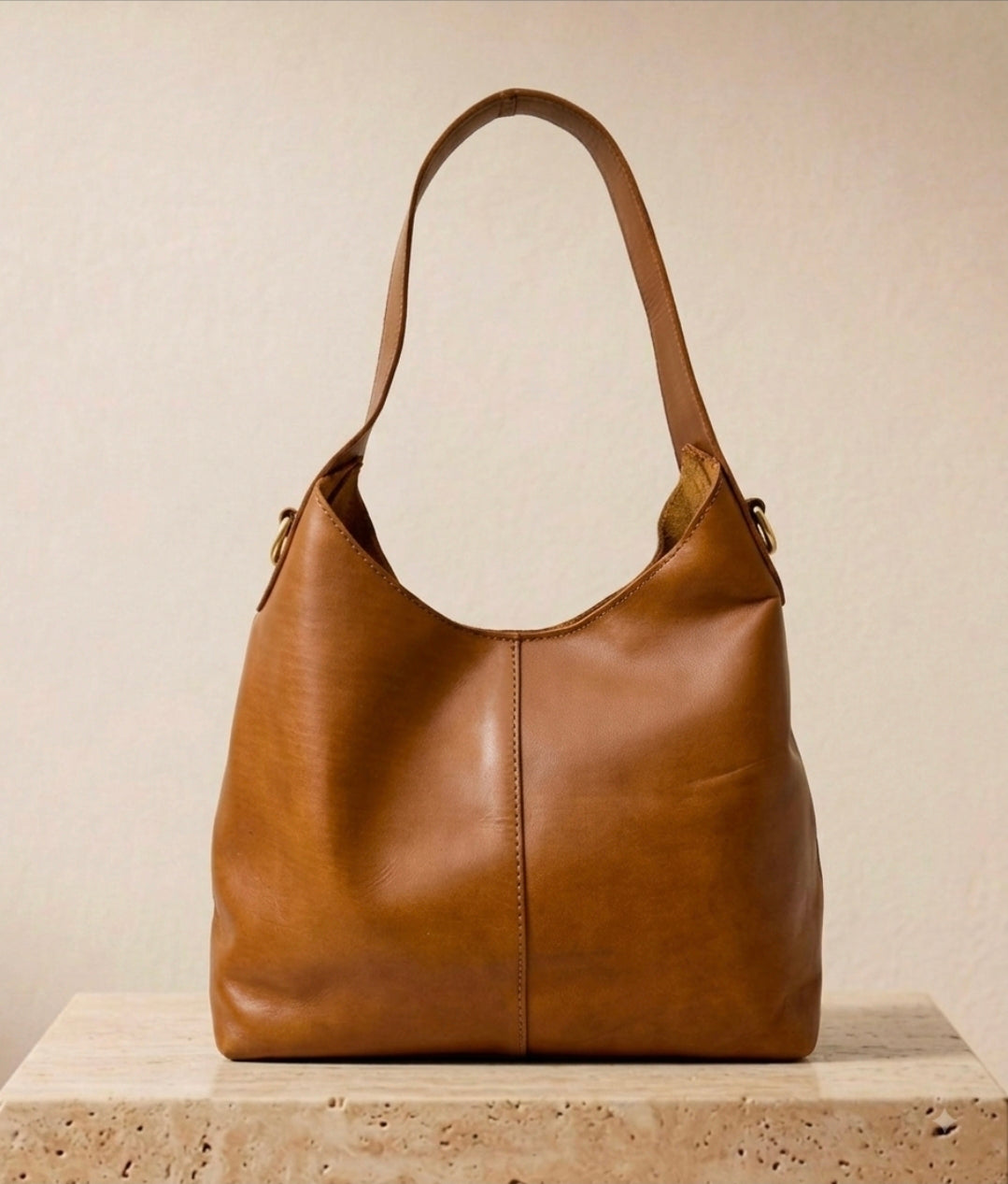 Rich tan smooth leather hobo shoulder bag with center seam detail and single strap