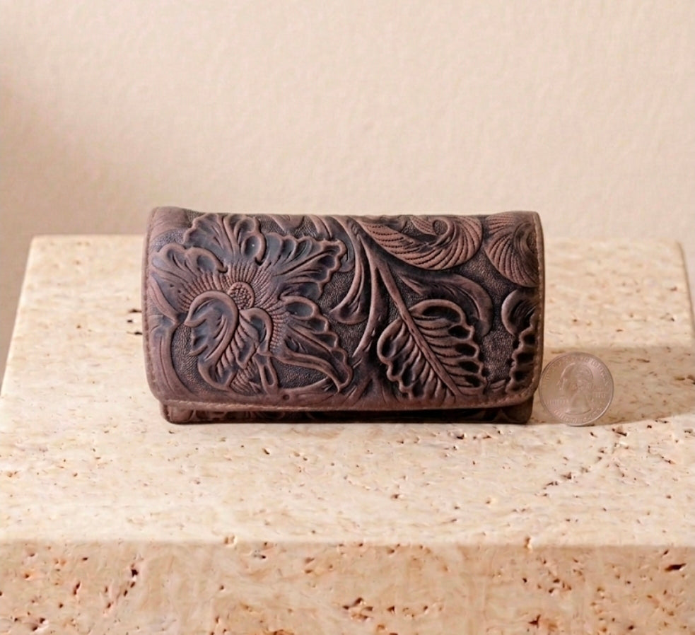 Brown hand-tooled leather billfold purse with deep floral carving