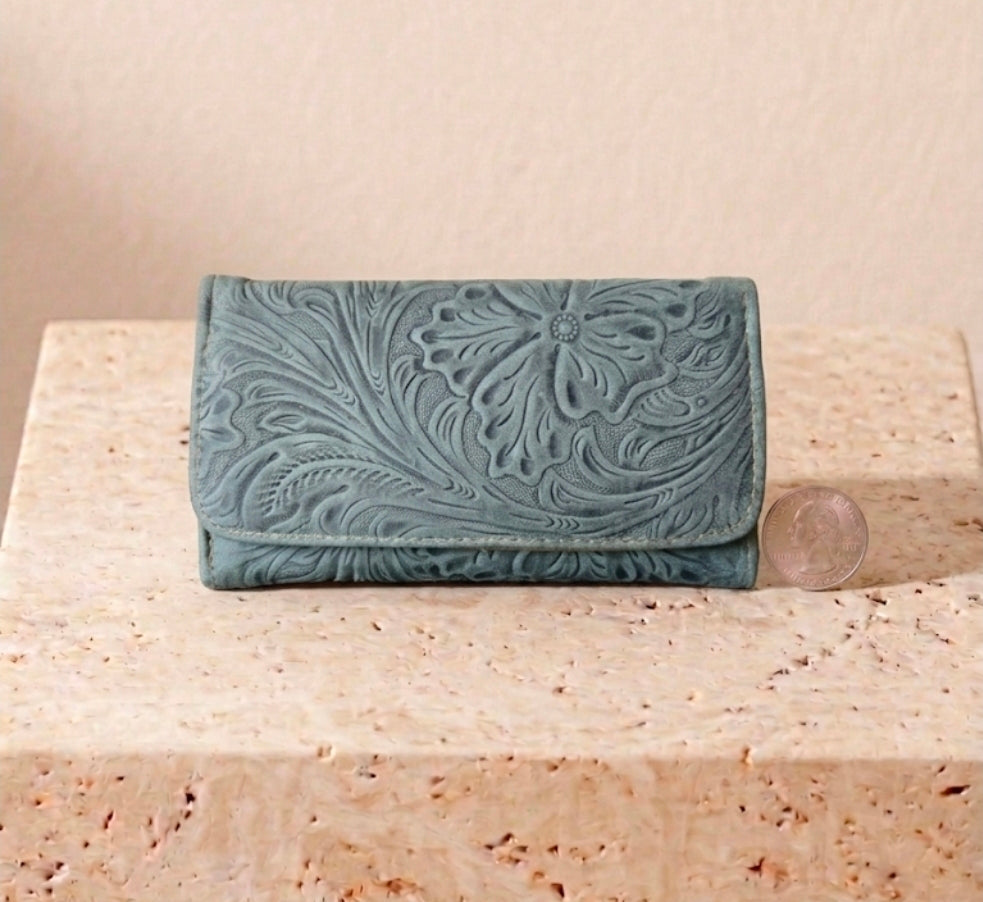 Sage green hand-tooled leather billfold purse with deep floral carving and brown interior
