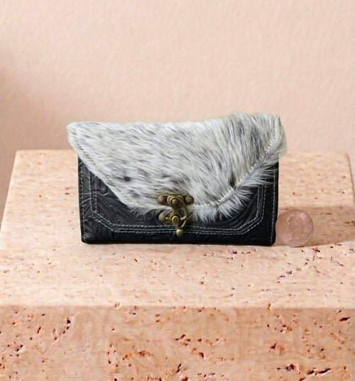 Black and white cowhide hand-tooled leather clutch with antique brass clasp