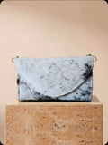 White and black cowhide cell phone wallet purse with gold hardware and shoulder strap