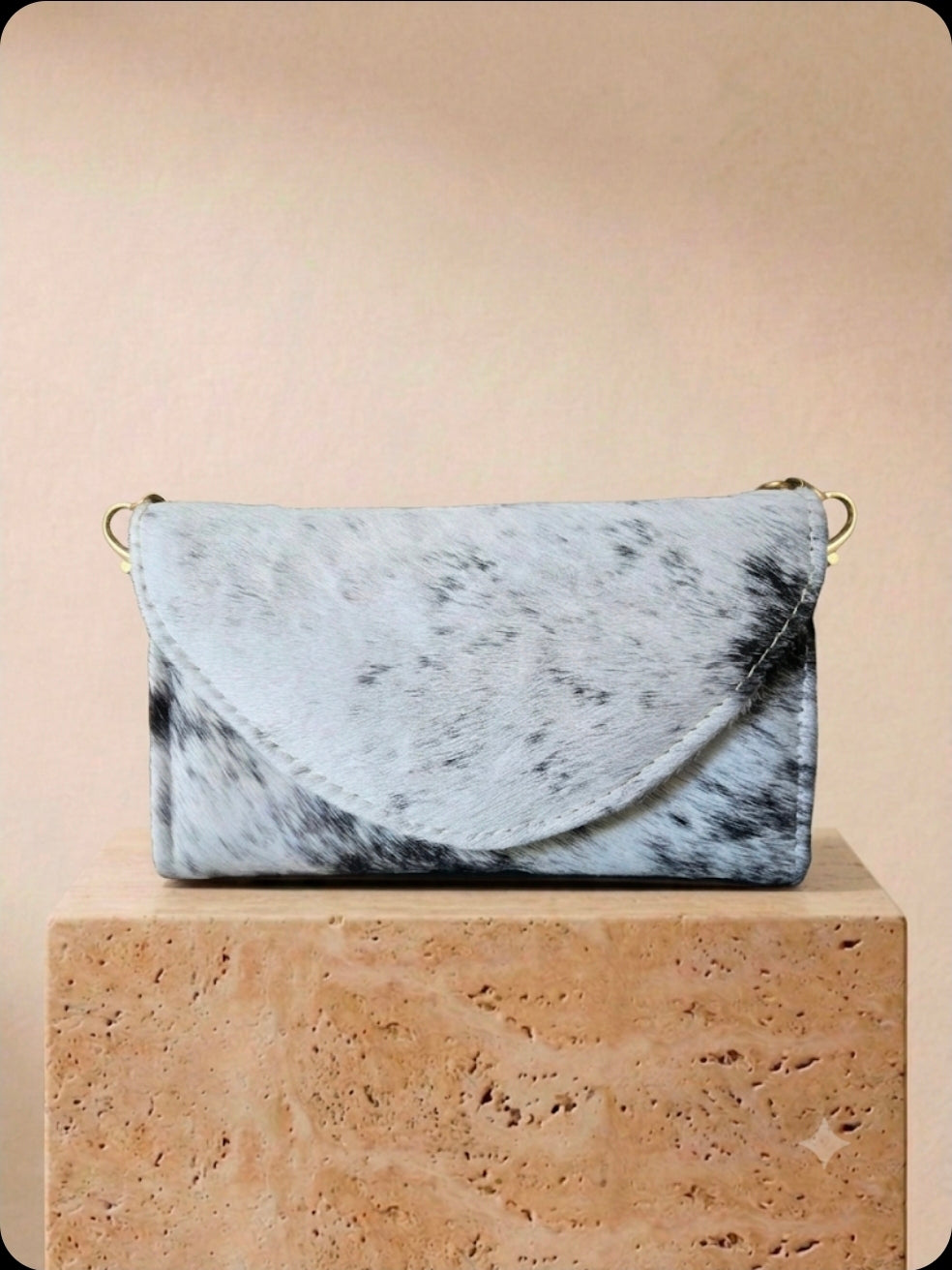White and black cowhide cell phone wallet purse with gold hardware and shoulder strap